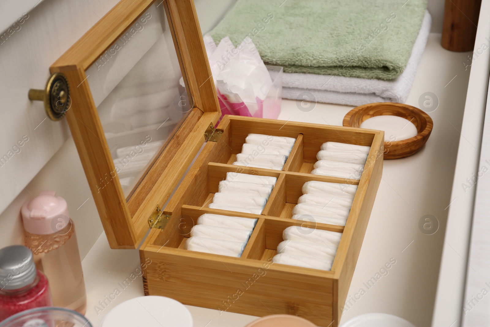 Photo of Storage of tampons and different hygiene products in white drawer