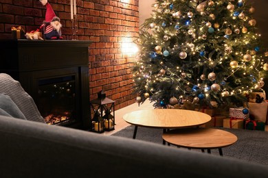 Beautiful tree with festive lights and Christmas decor in living room. Interior design