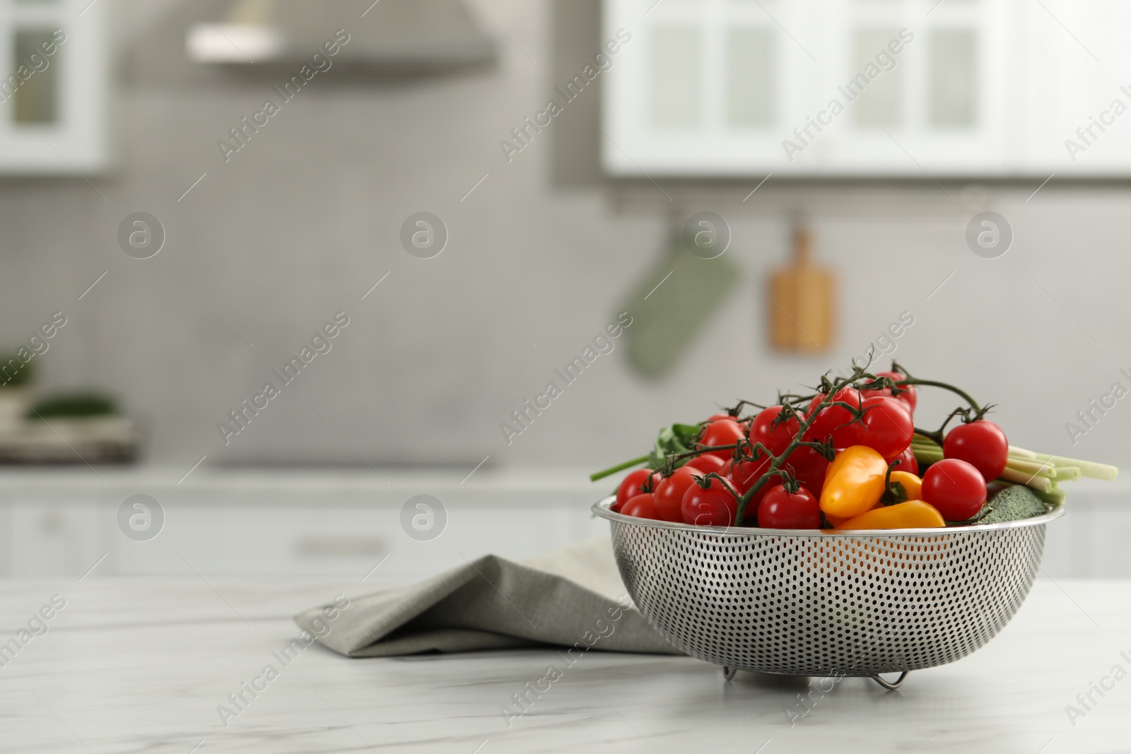 Photo of Fresh clean vegetables on white table in kitchen, space for text