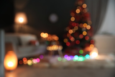 Photo of Blurred view of stylish room interior with decorated Christmas tree