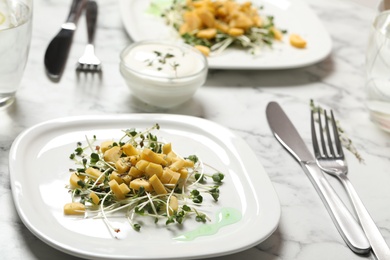 Photo of Delicious fresh carrot salad on white marble table, closeup