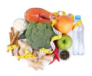 Photo of Metabolism. Different food products and measuring tape on white background, top view
