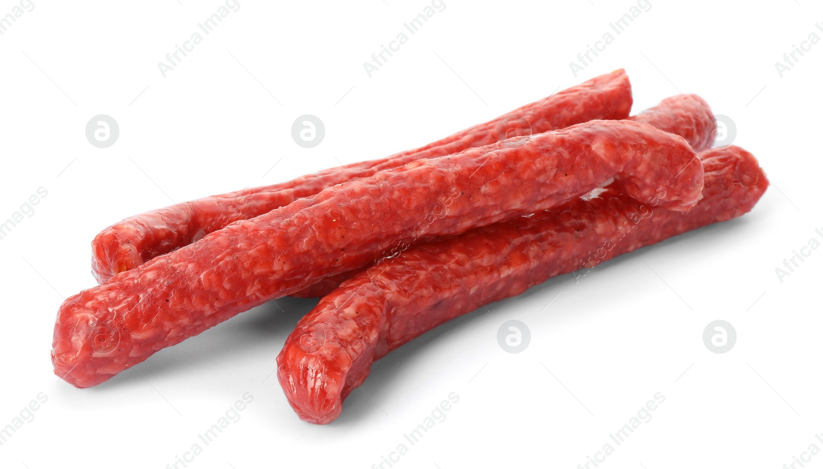 Photo of Thin dry smoked sausages isolated on white