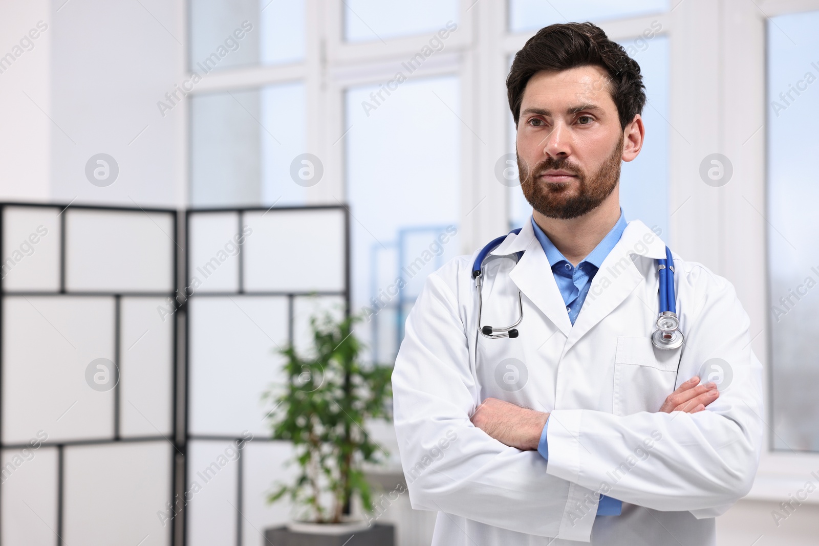 Photo of Medical consultant with stethoscope in clinic, space for text