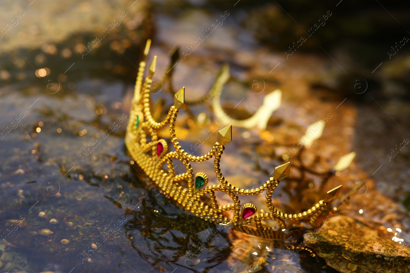 Photo of Beautiful golden crown near river, closeup. Fantasy item