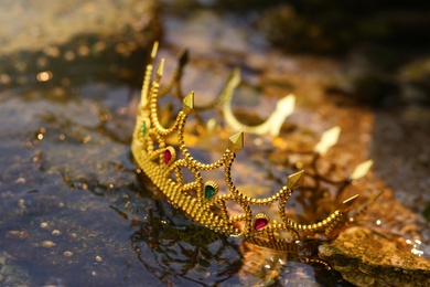 Photo of Beautiful golden crown near river, closeup. Fantasy item