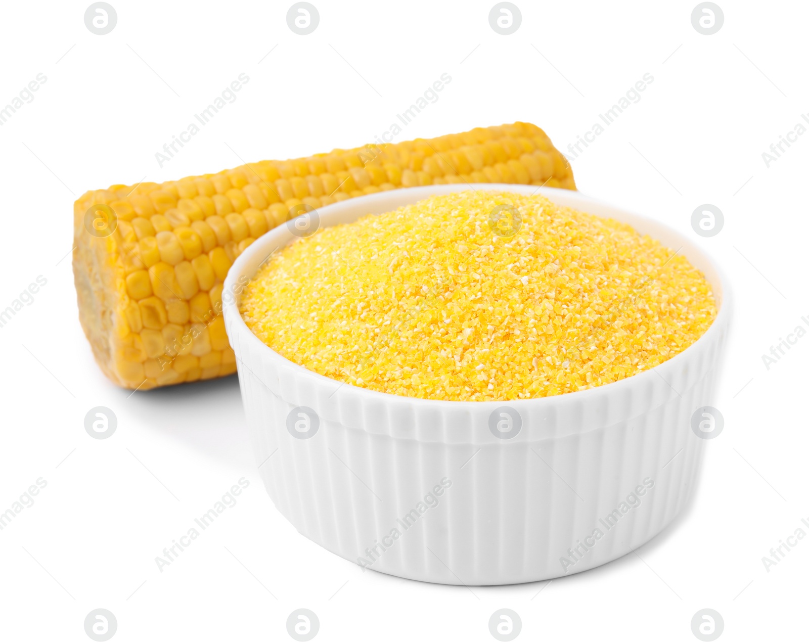 Photo of Raw cornmeal in bowl and corn cob isolated on white
