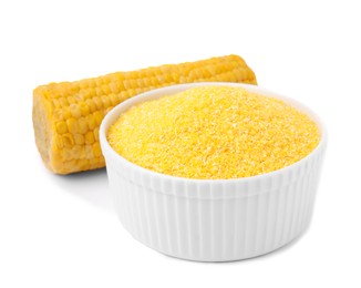 Raw cornmeal in bowl and corn cob isolated on white