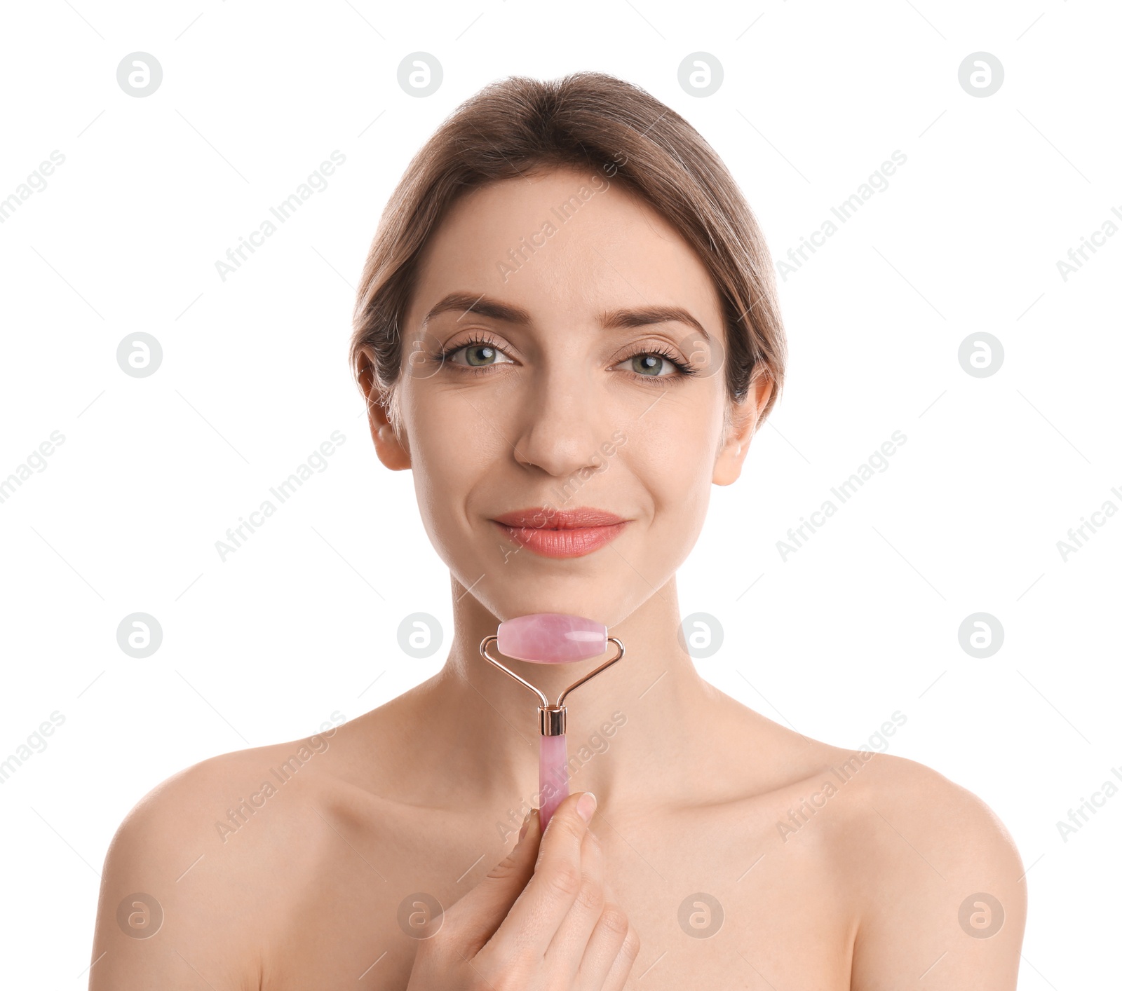 Photo of Young woman using natural rose quartz face roller on white background