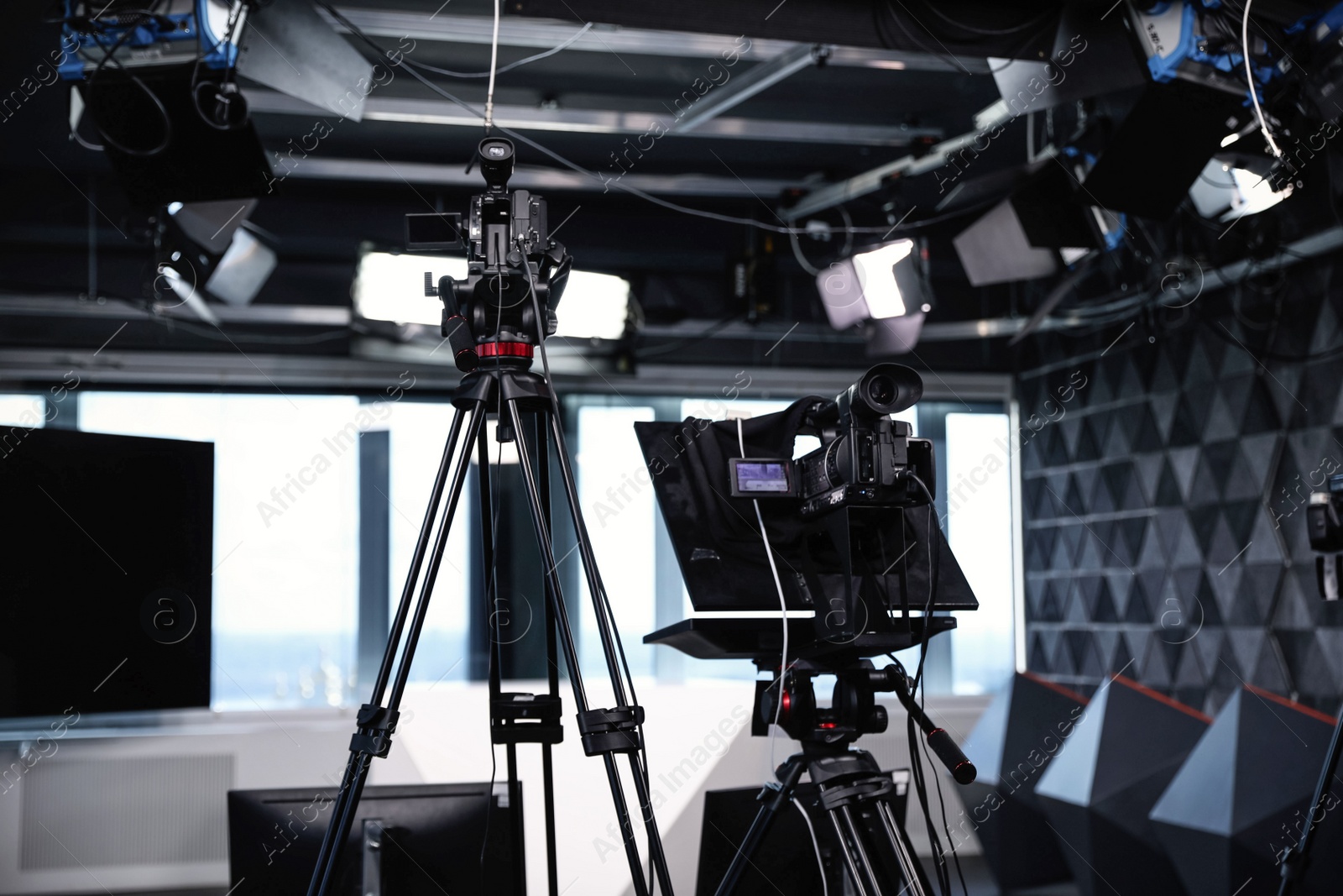 Photo of Modern video recording studio with professional cameras