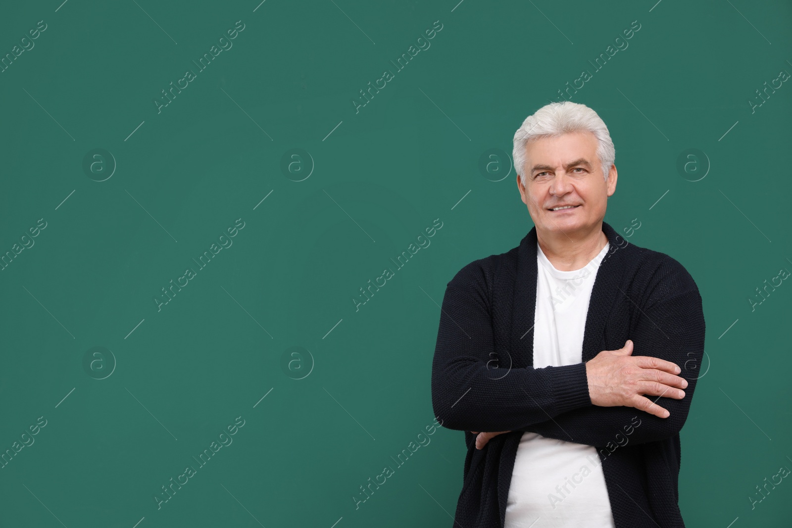 Photo of Portrait of senior teacher at green chalkboard, space for text