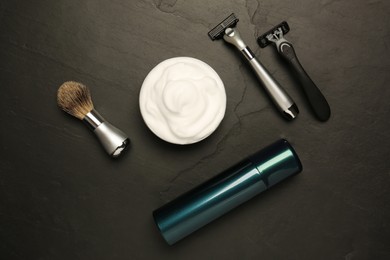 Photo of Set of men's shaving tools on black textured table, flat lay