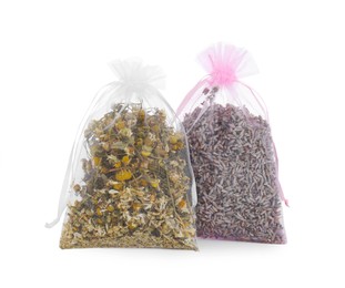 Scented sachets with dried flowers on white background