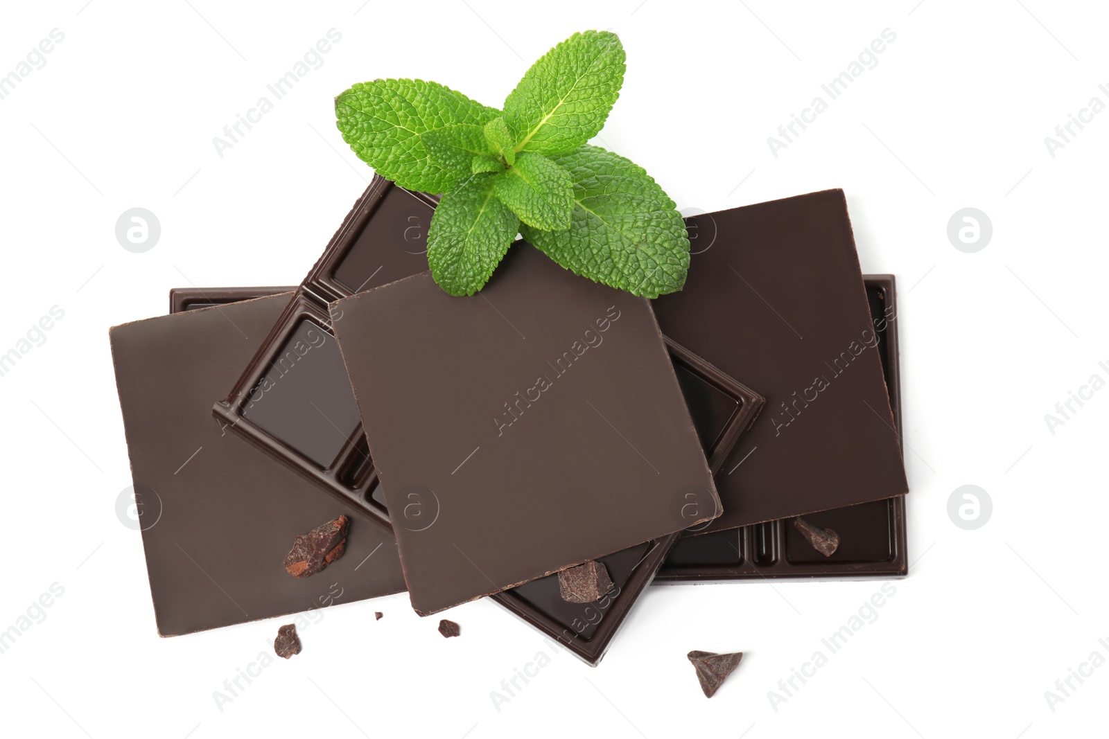 Photo of Tasty dark chocolate pieces with mint on white background, top view