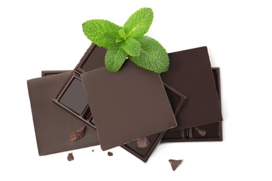 Photo of Tasty dark chocolate pieces with mint on white background, top view