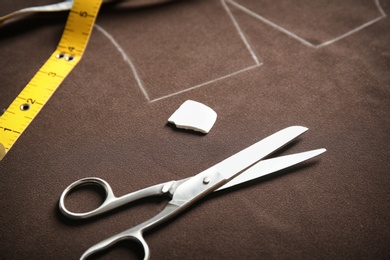 Photo of Tailoring tools on fabric with pattern template