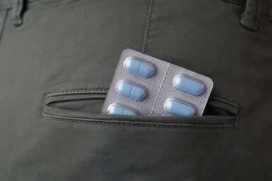 Jeans with pills in pocket, closeup. Potency problem