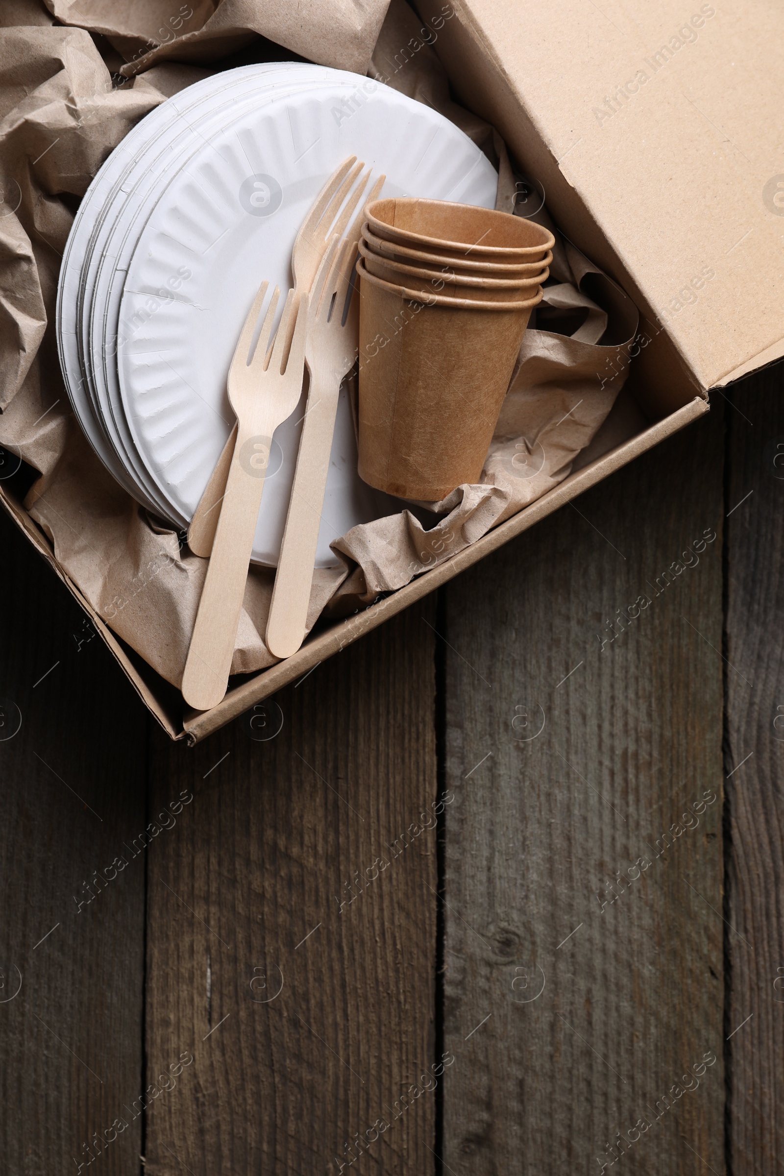 Photo of Box of waste paper on wooden table, top view. Space for text