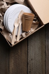 Photo of Box of waste paper on wooden table, top view. Space for text