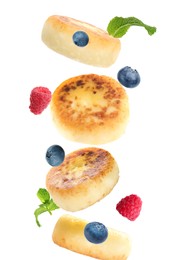 Image of Delicious cottage cheese pancakes, mint and berries falling on white background