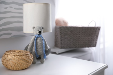 Photo of Baby accessories and toys on table in room