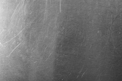 Photo of Old metal surface with scratches as background, closeup