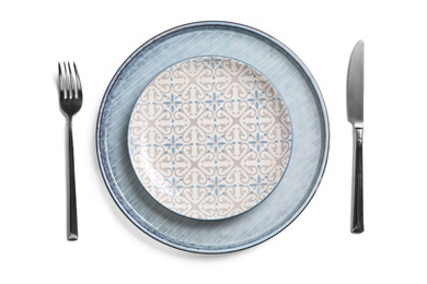 Beautiful table setting with cutlery and plates on white background, top view
