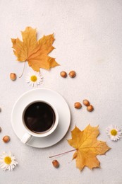 Photo of Flat lay composition with cup of hot drink and autumn leaves on light grey textured table