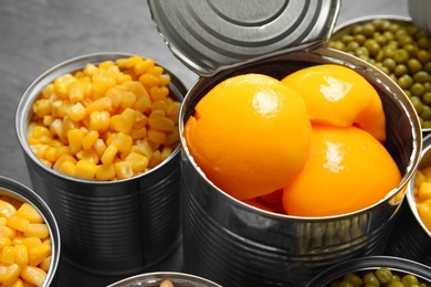 Open tin cans with conserved products, closeup