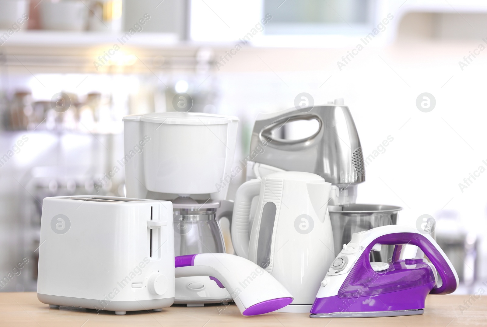 Photo of Household and kitchen appliances on table indoors. Interior element