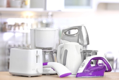 Photo of Household and kitchen appliances on table indoors. Interior element