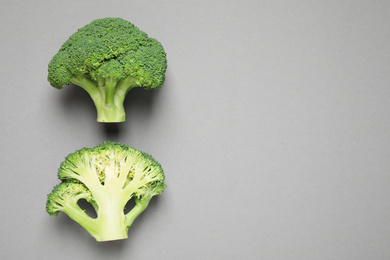 Fresh tasty broccoli on grey background, flat lay. Space for text