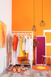 Stylish dressing room interior with clothes rack and mirror