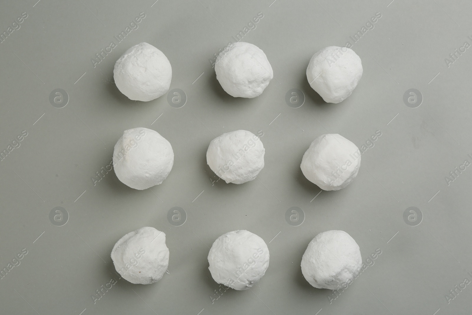 Photo of Round snowballs on grey background, flat lay