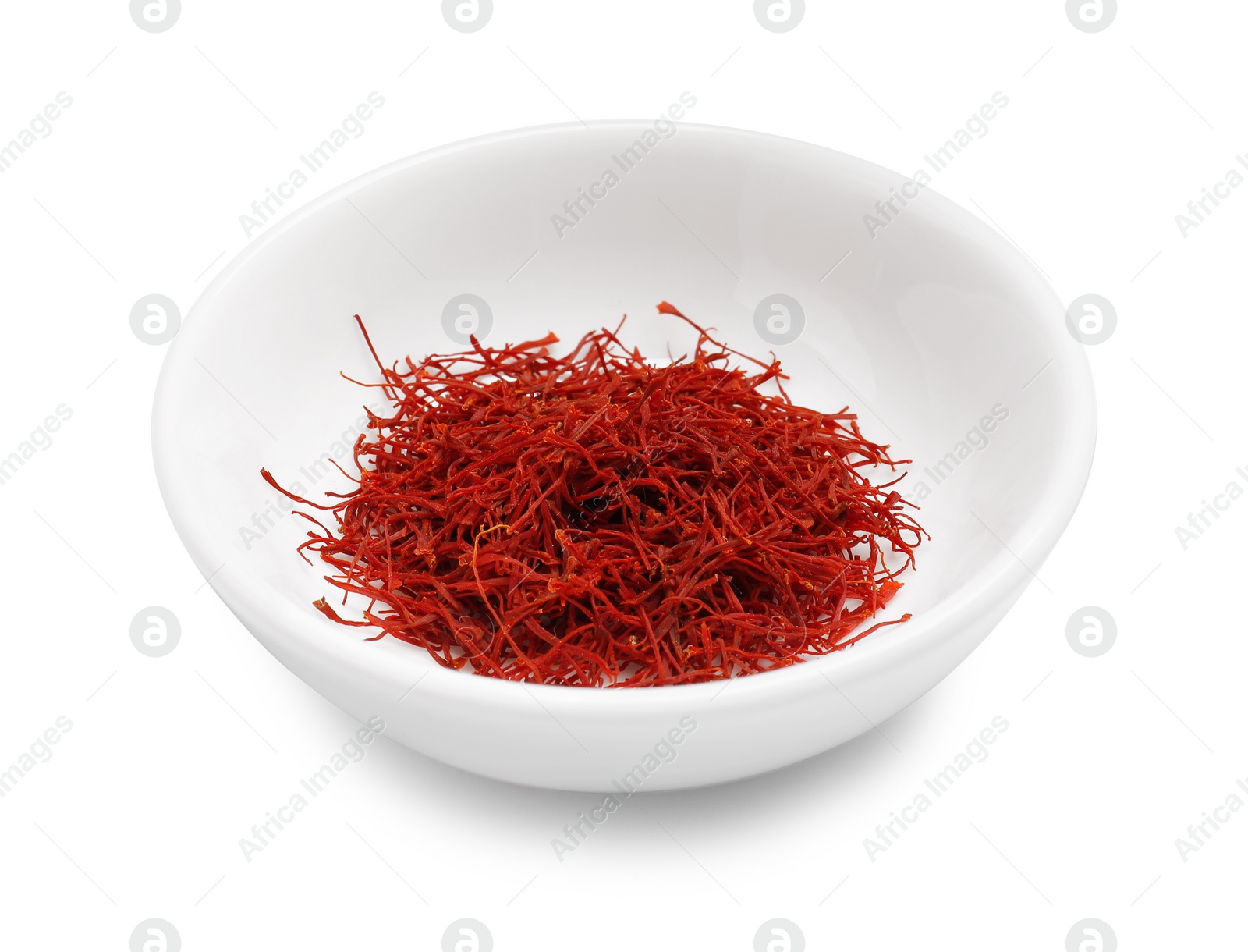 Photo of Aromatic saffron in bowl isolated on white