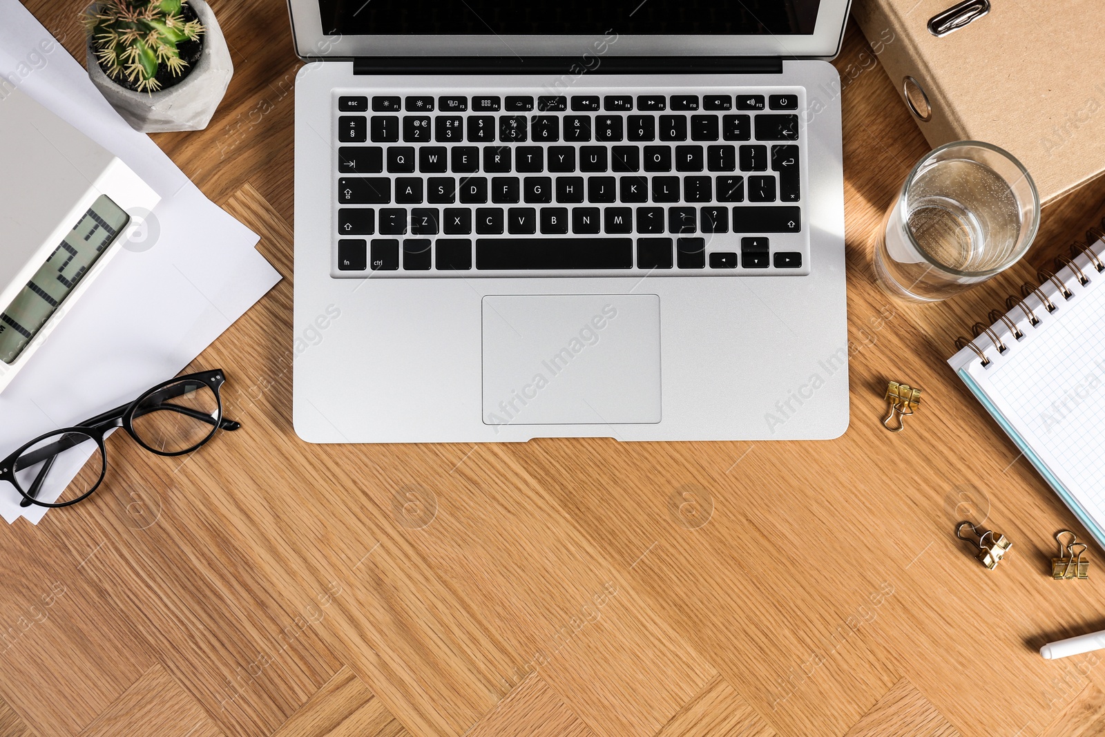 Photo of Flat lay composition with laptop and stationery on office table