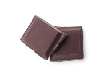 Pieces of delicious dark chocolate bar on white background, top view