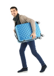 Photo of Young man with suitcase on white background. Ready for winter vacation