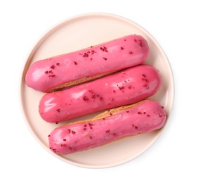 Delicious eclairs covered with pink glaze isolated on white, top view