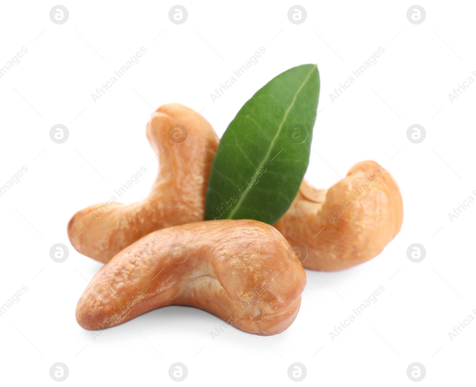 Photo of Tasty organic cashew nuts and green leaf isolated on white