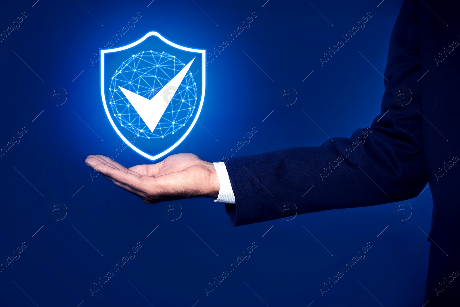 Image of Anti-fraud security system. Man with illustration of checkmark in shield on blue background, closeup