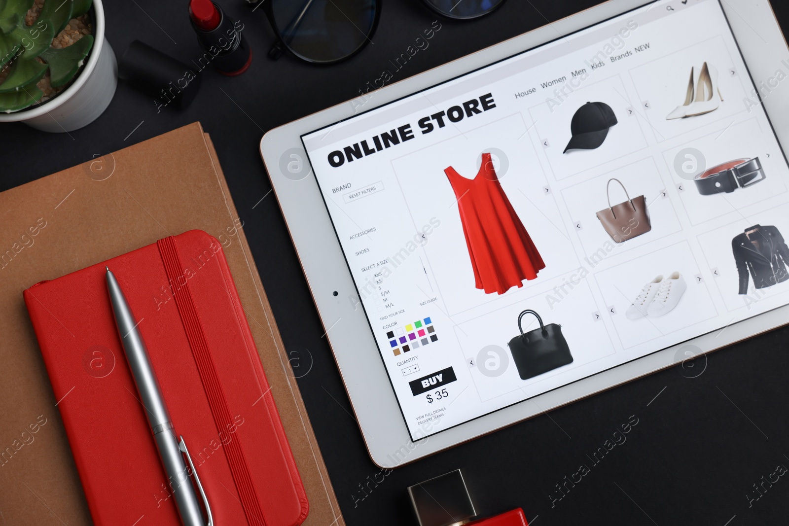 Photo of Online shopping. Flat lay composition with modern tablet on black background