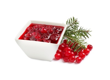 Photo of Cranberry sauce, fir tree twigs and fresh berries on white background