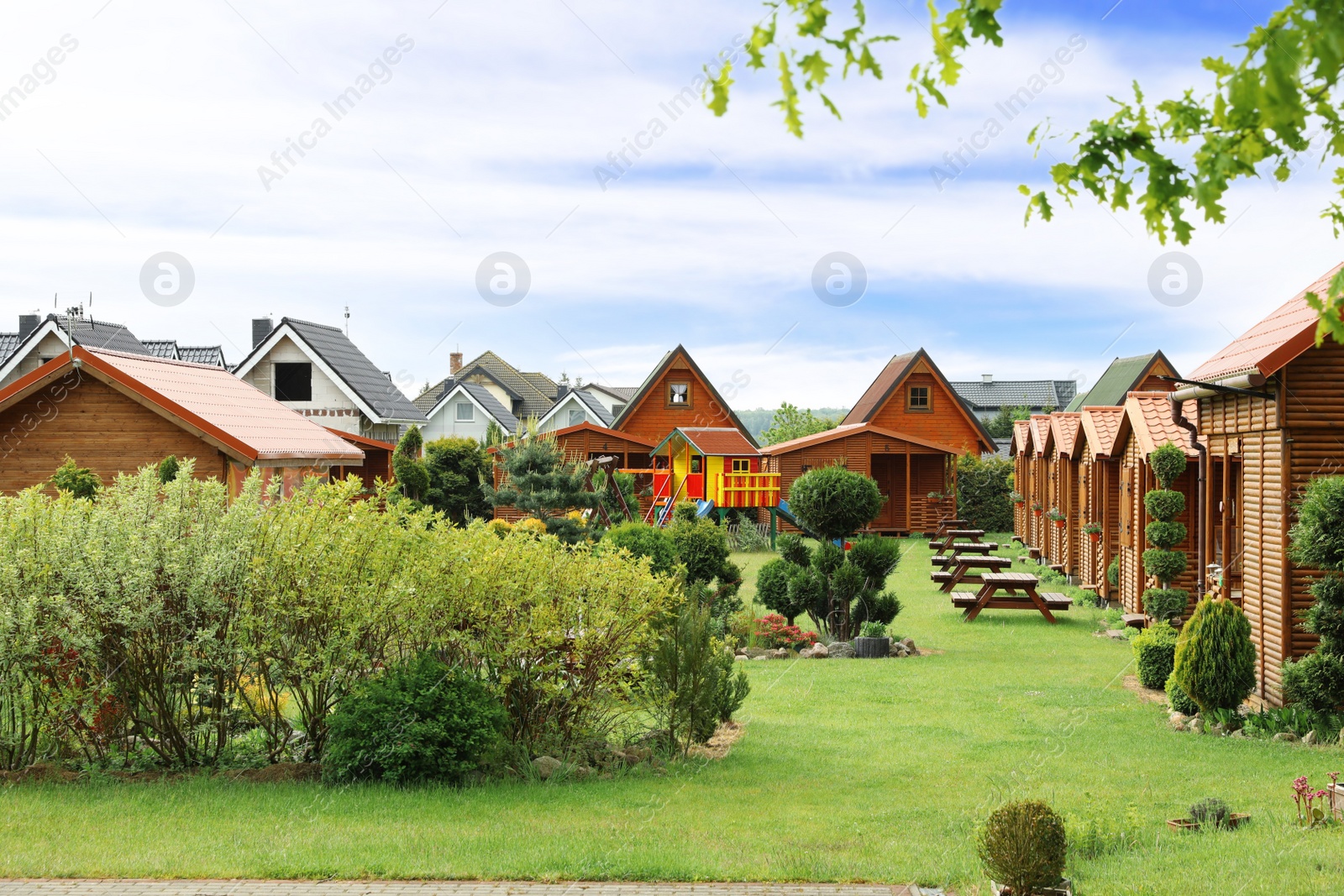 Photo of Beautiful houses and green garden on sunny day