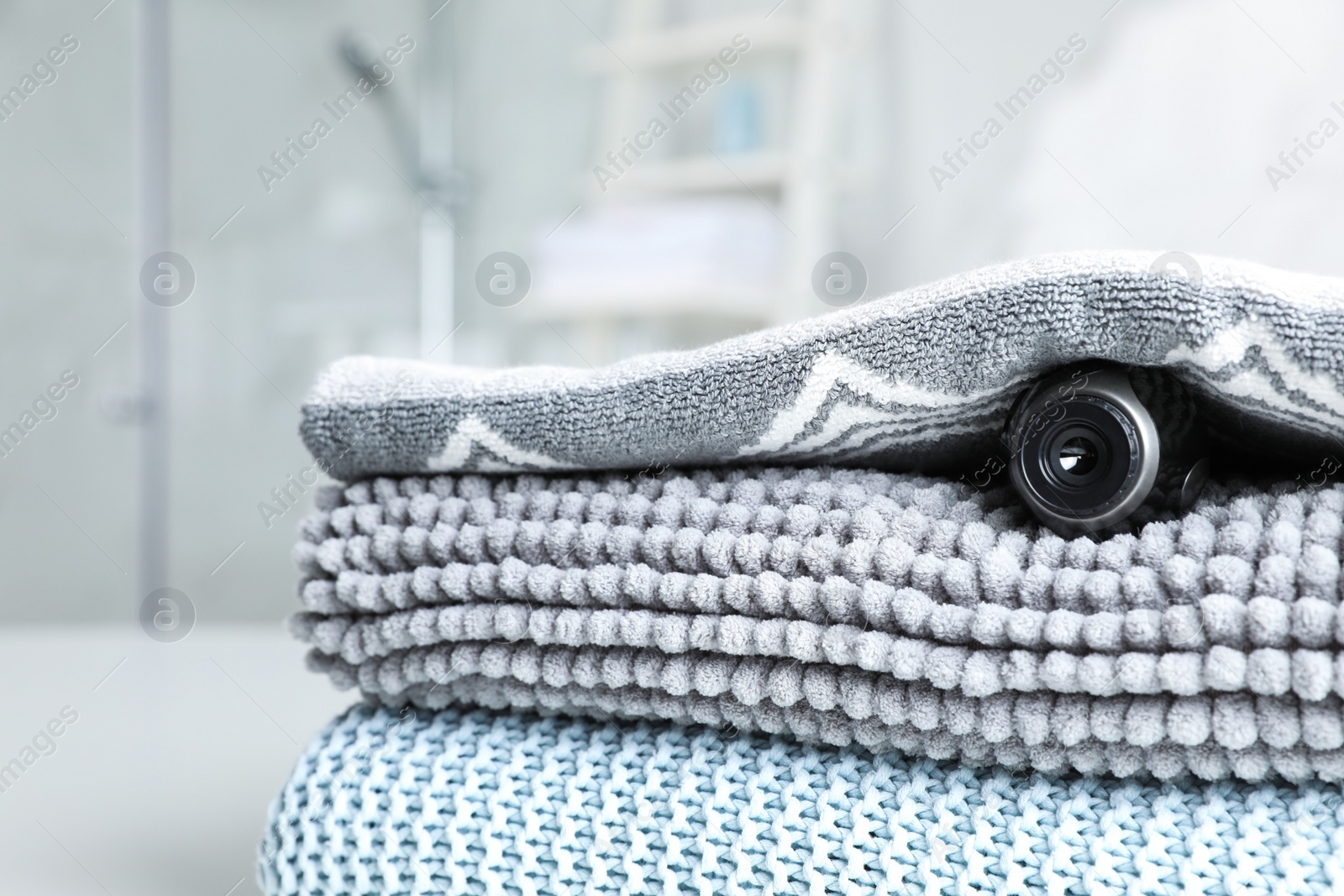 Photo of Camera hidden under towel in bathroom, closeup