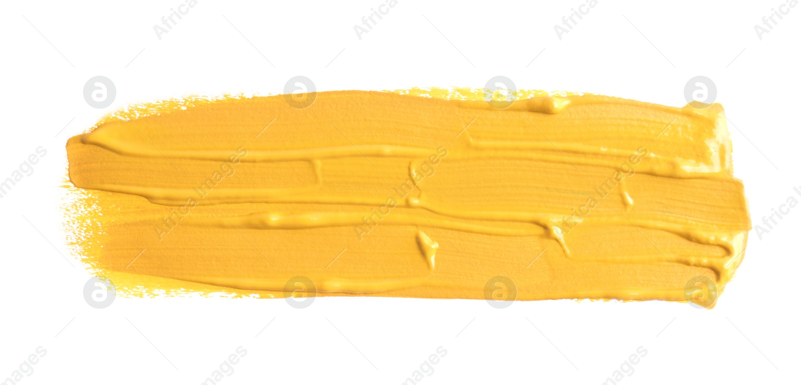 Photo of Yellow paint stroke drawn with brush on white background, top view