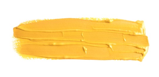 Photo of Yellow paint stroke drawn with brush on white background, top view