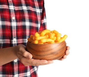 Photo of Woman holding bowl of crunchy cheesy corn sticks on white background, closeup