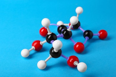 Molecule of vitamin C on light blue background. Chemical model