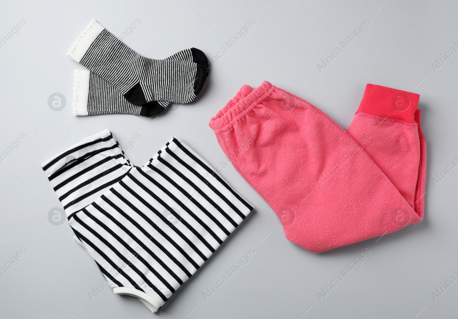 Photo of Flat lay composition with cute child clothes on color background